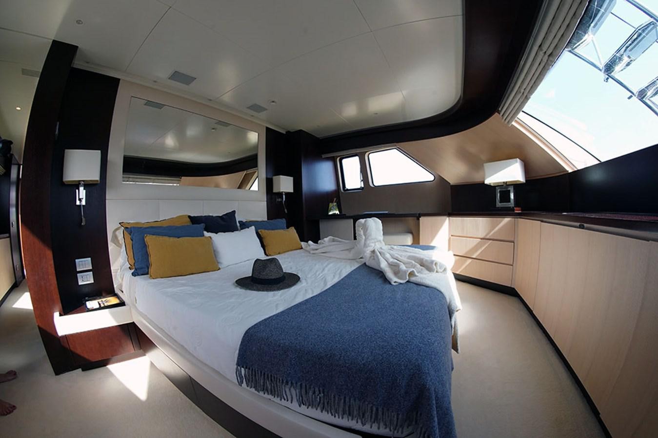 a room with a bed and a desk aboard AKUA Yacht for Sale
