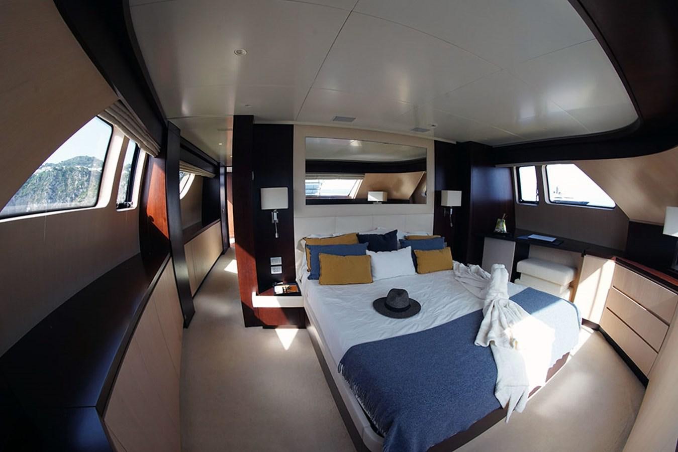 a room with a bed and a television aboard AKUA Yacht for Sale