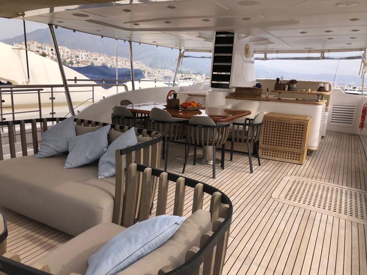 a boat with a table and chairs aboard AKUA Yacht for Sale