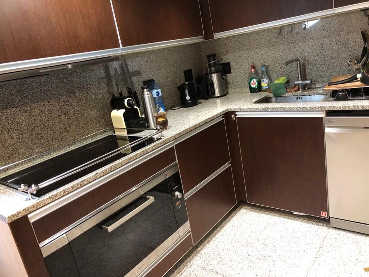 a kitchen with a stainless steel oven aboard AKUA Yacht for Sale