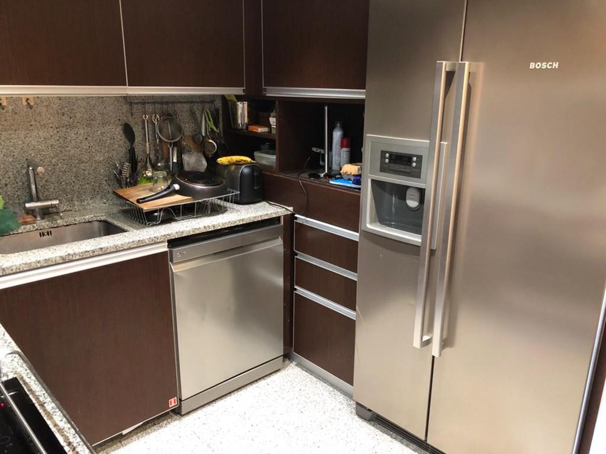 a kitchen with stainless steel appliances aboard AKUA Yacht for Sale