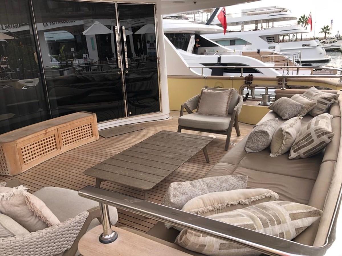 a living room with a couch and a table aboard AKUA Yacht for Sale