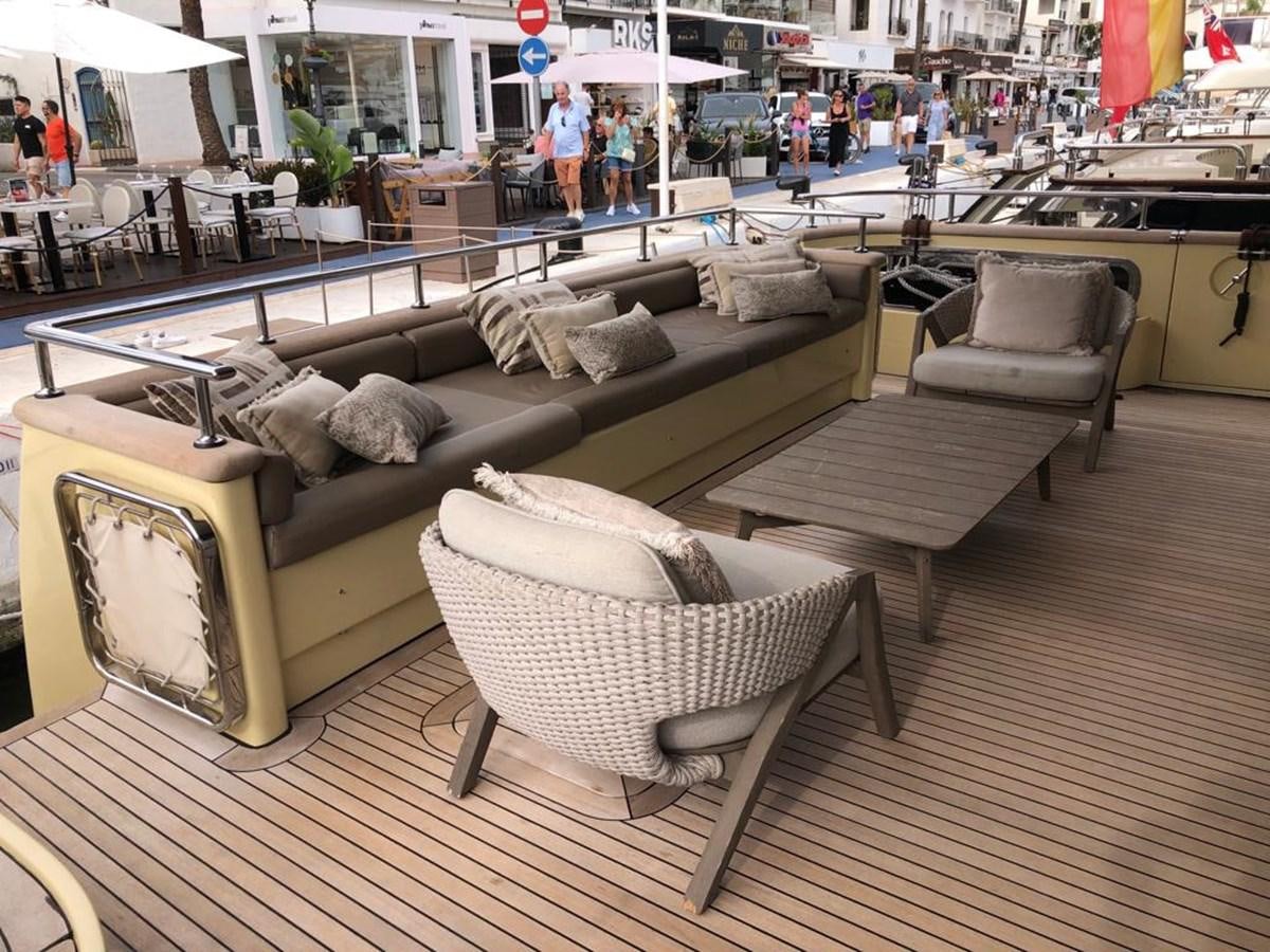 a room with couches and tables aboard AKUA Yacht for Sale