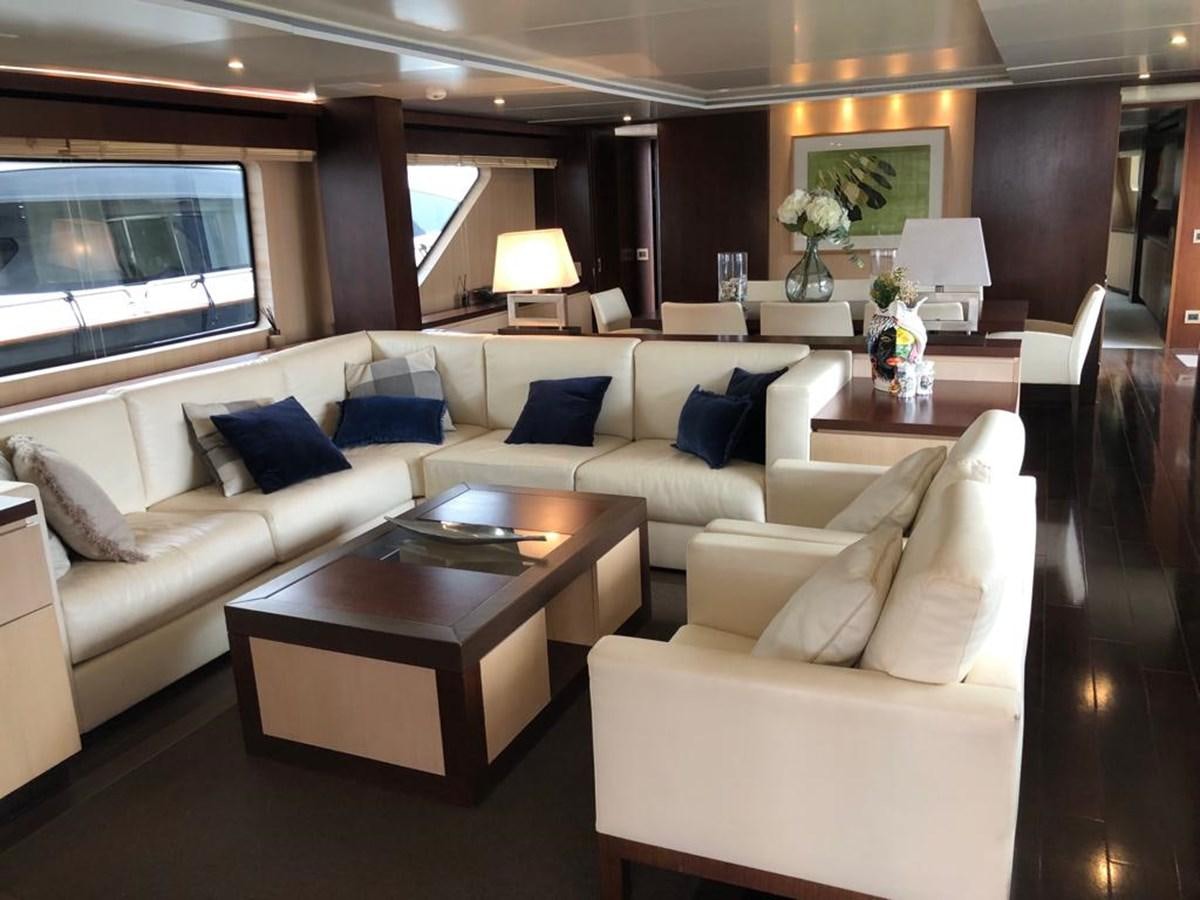 a living room with a couch and a coffee table aboard AKUA Yacht for Sale