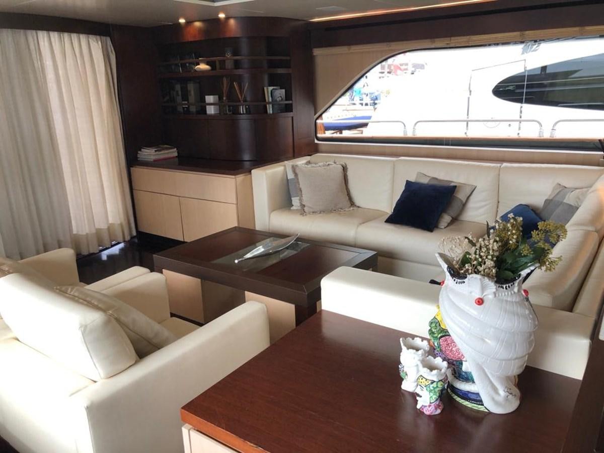 a living room with a couch and a coffee table aboard AKUA Yacht for Sale