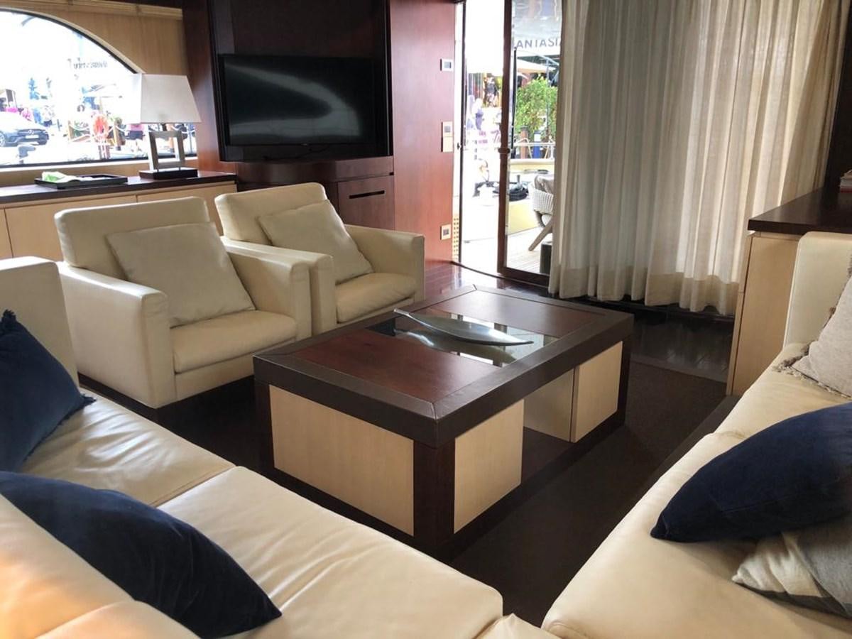 a living room with a coffee table aboard AKUA Yacht for Sale