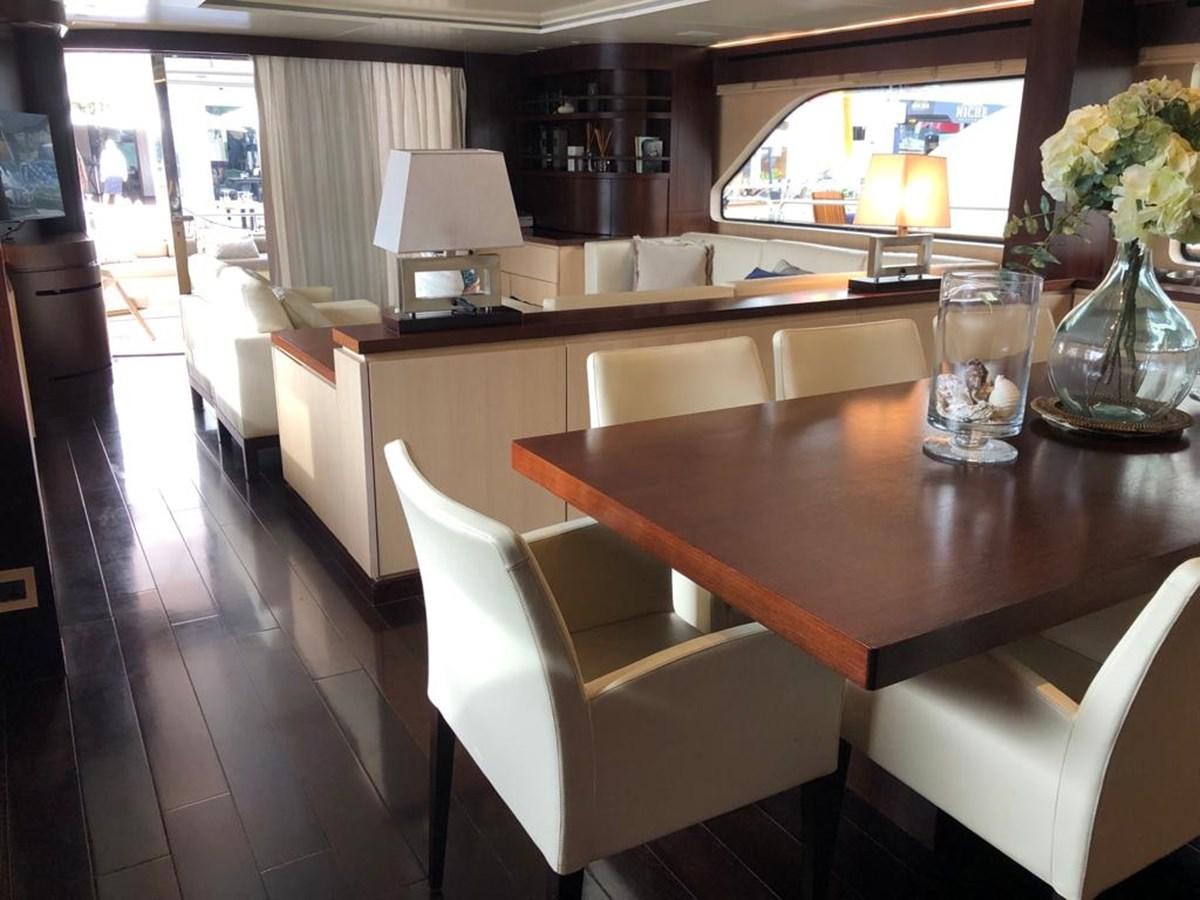 a room with a table and chairs aboard AKUA Yacht for Sale