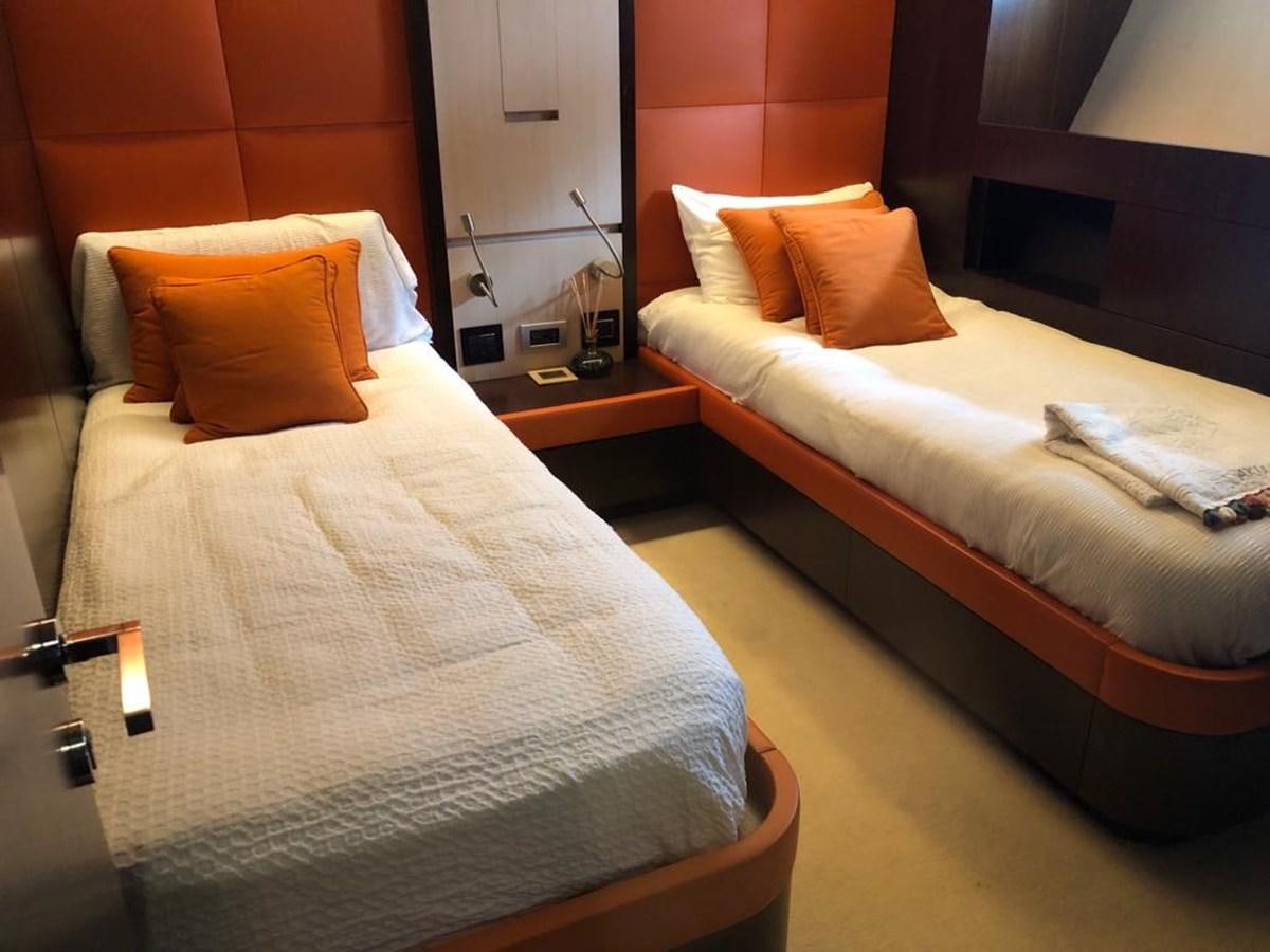 a hotel room with two beds aboard AKUA Yacht for Sale