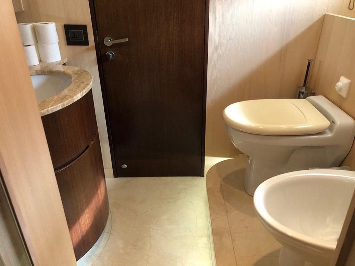 a bathroom with a toilet and sink aboard AKUA Yacht for Sale