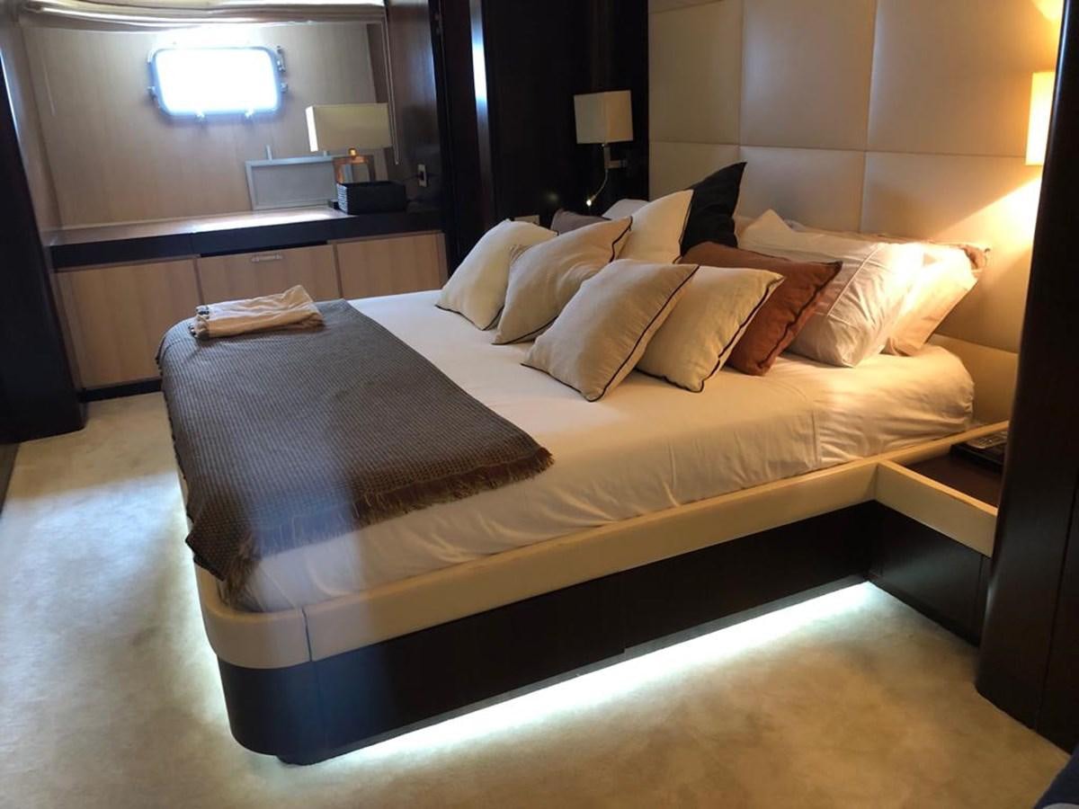 a bed with a white comforter aboard AKUA Yacht for Sale