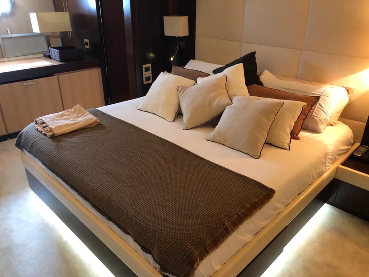 a bed with a white comforter aboard AKUA Yacht for Sale