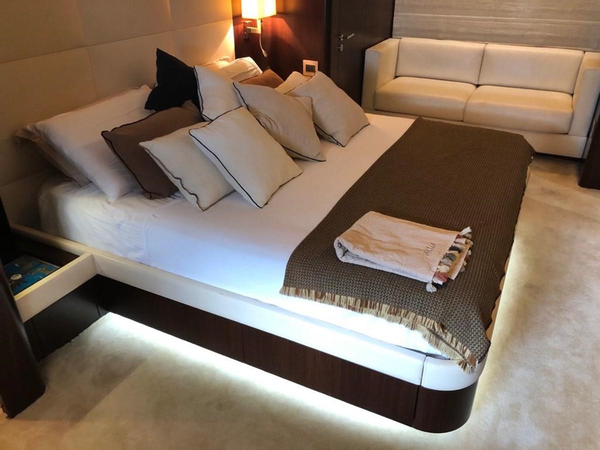 a bed with a black and white bed spread aboard AKUA Yacht for Sale