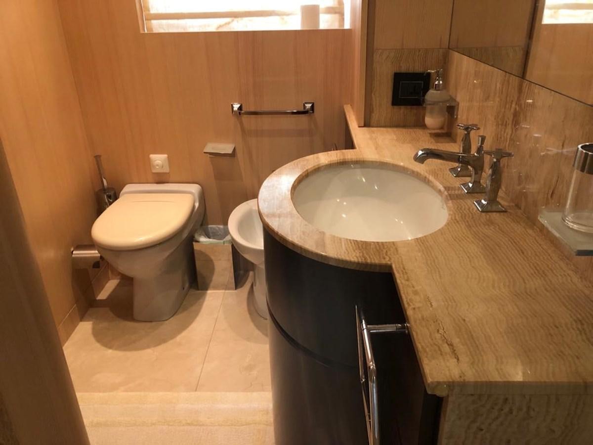 a bathroom with a sink and toilet aboard AKUA Yacht for Sale