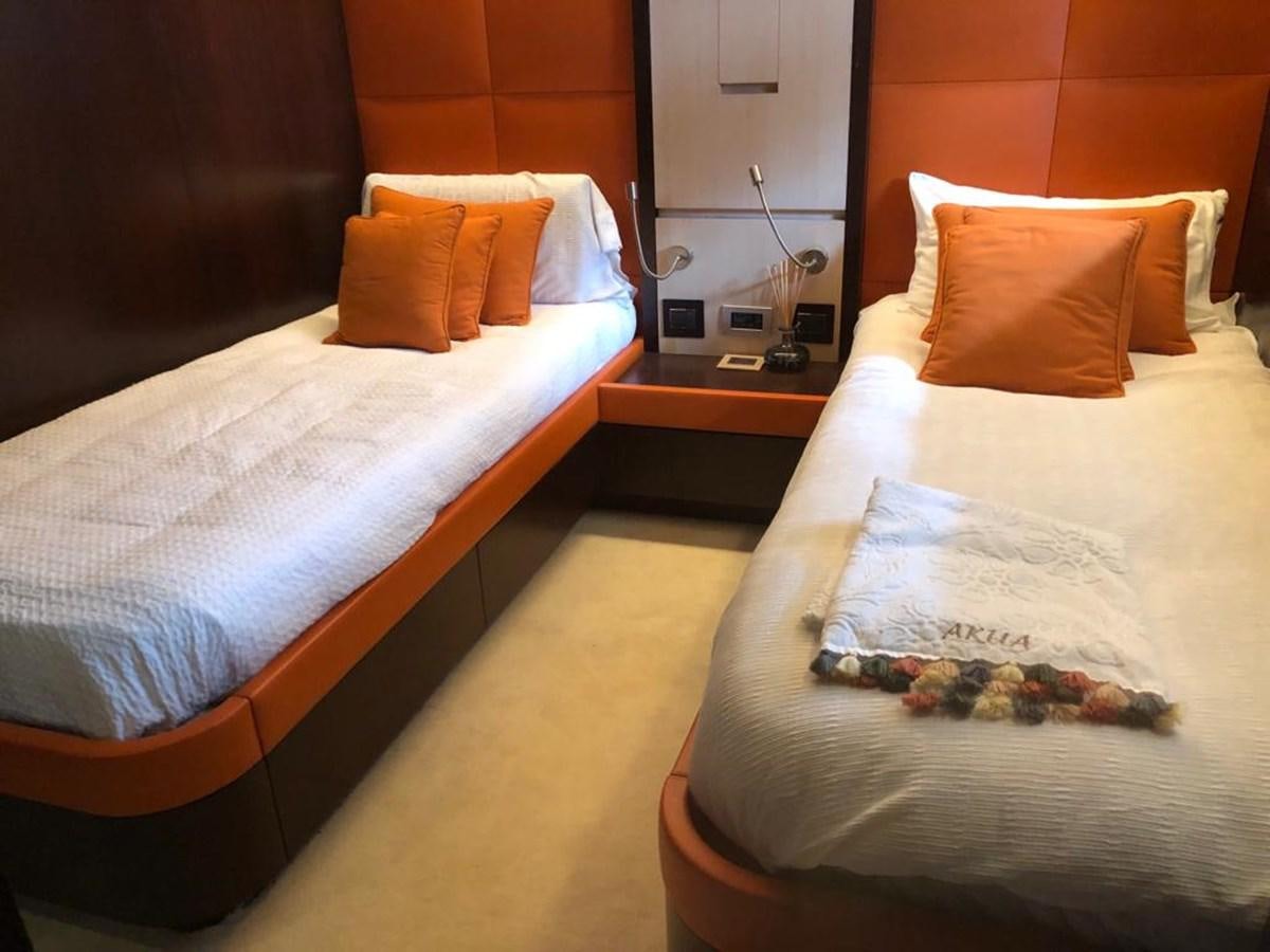 a couple of beds in a hotel room aboard AKUA Yacht for Sale