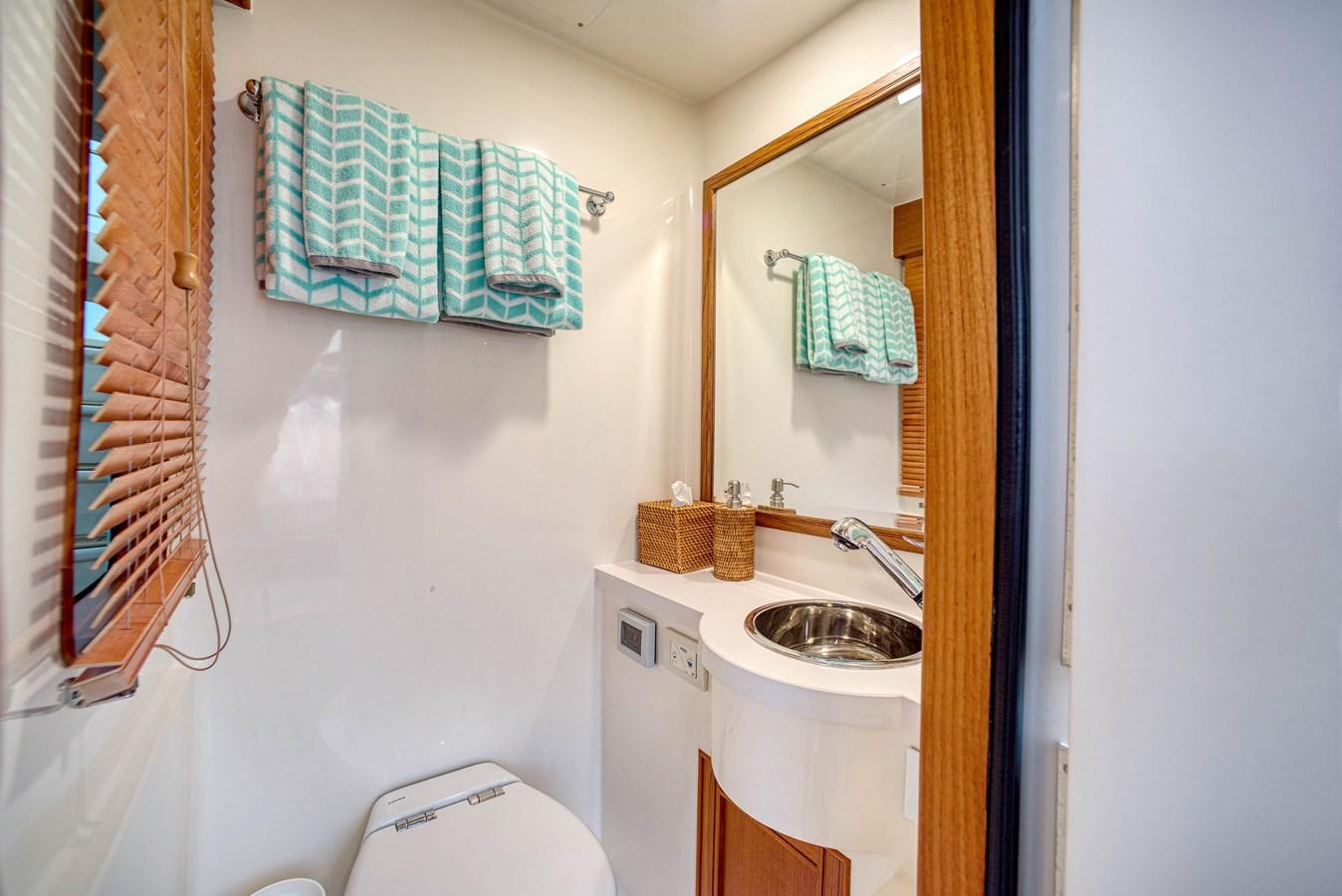 a bathroom with a sink and a toilet aboard QUIXOTIC Yacht for Sale
