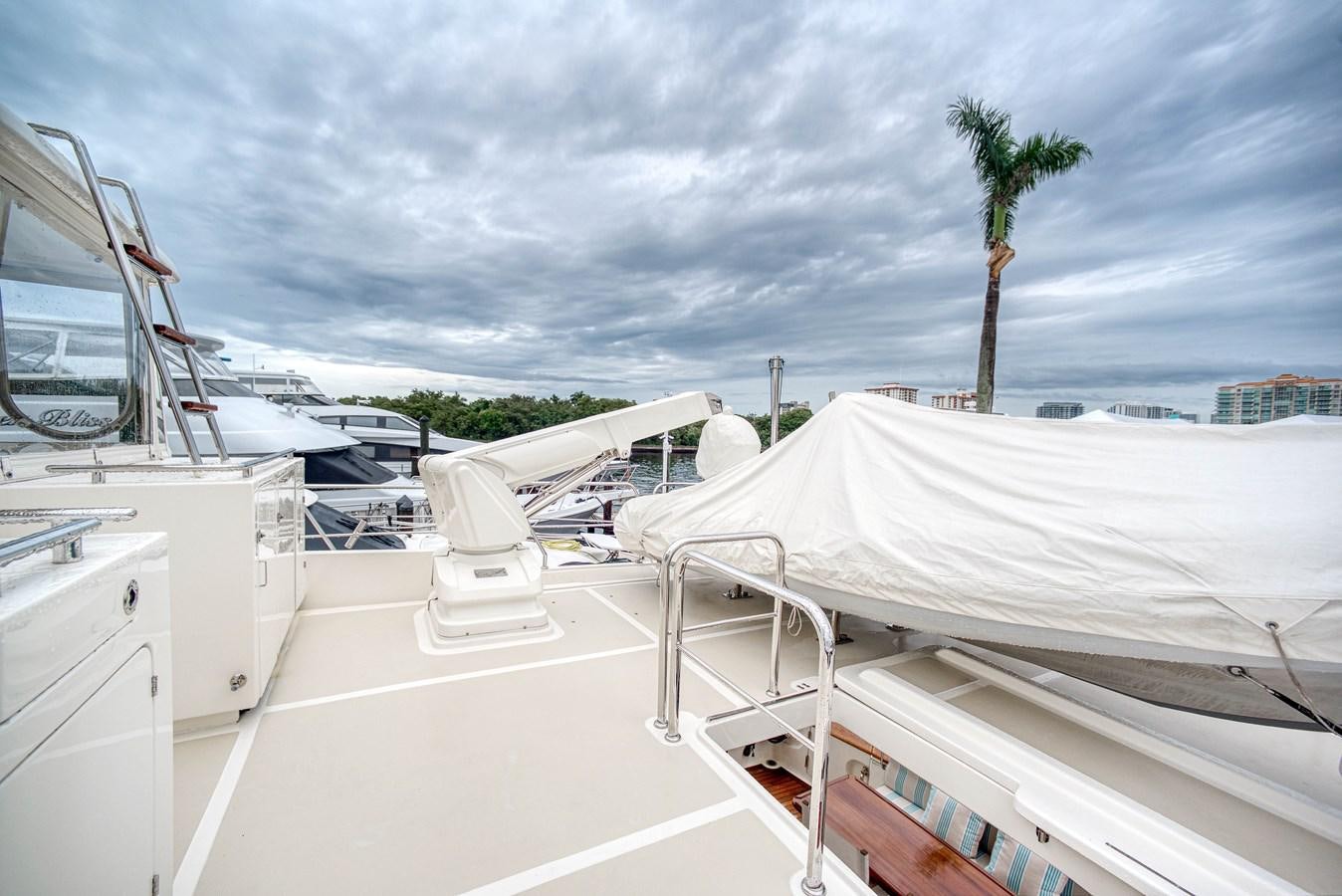 a white boat with a white canopy aboard QUIXOTIC Yacht for Sale