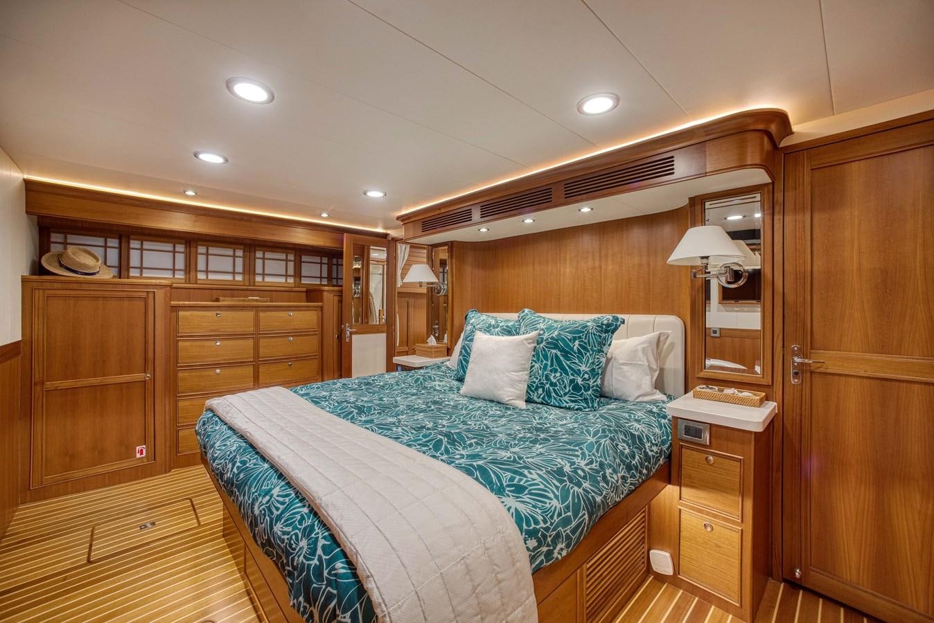 a bedroom with a bed and a closet aboard QUIXOTIC Yacht for Sale