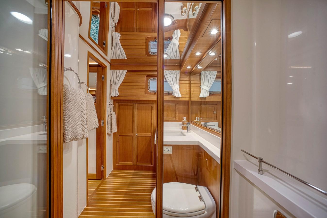 a bathroom with a toilet and a sink aboard QUIXOTIC Yacht for Sale