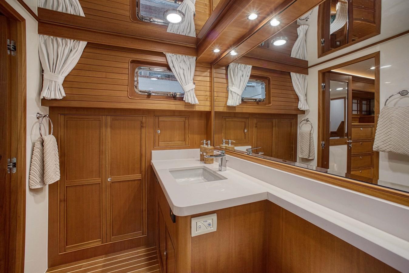 a bathroom with a sink and a mirror aboard QUIXOTIC Yacht for Sale