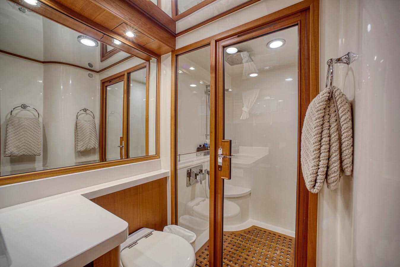 a bathroom with a large mirror aboard QUIXOTIC Yacht for Sale