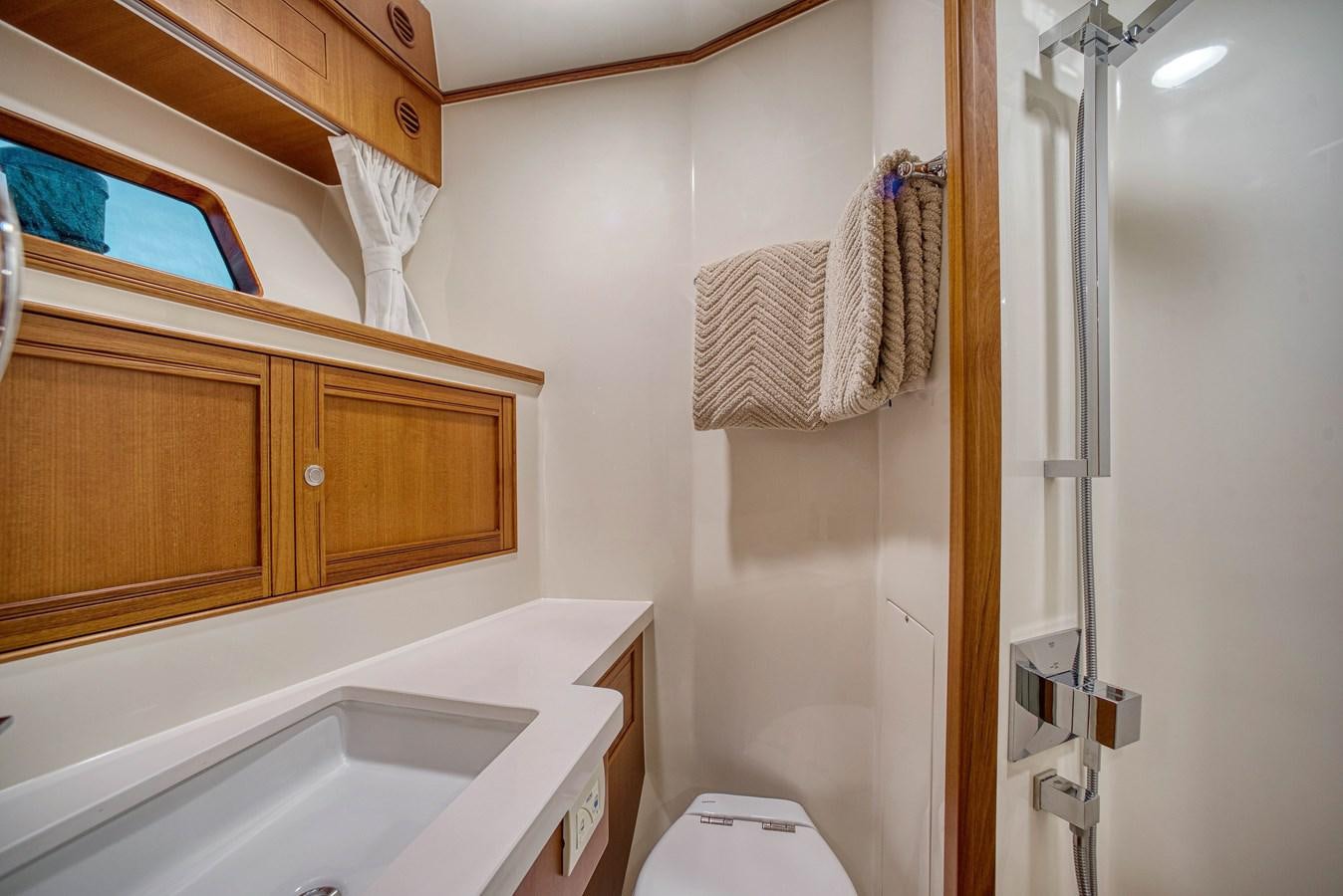 a bathroom with a shower and sink aboard QUIXOTIC Yacht for Sale
