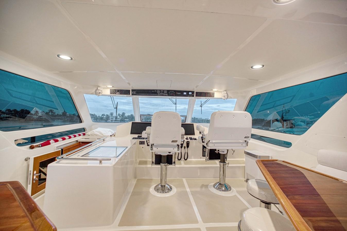 an empty room with chairs and a table aboard QUIXOTIC Yacht for Sale