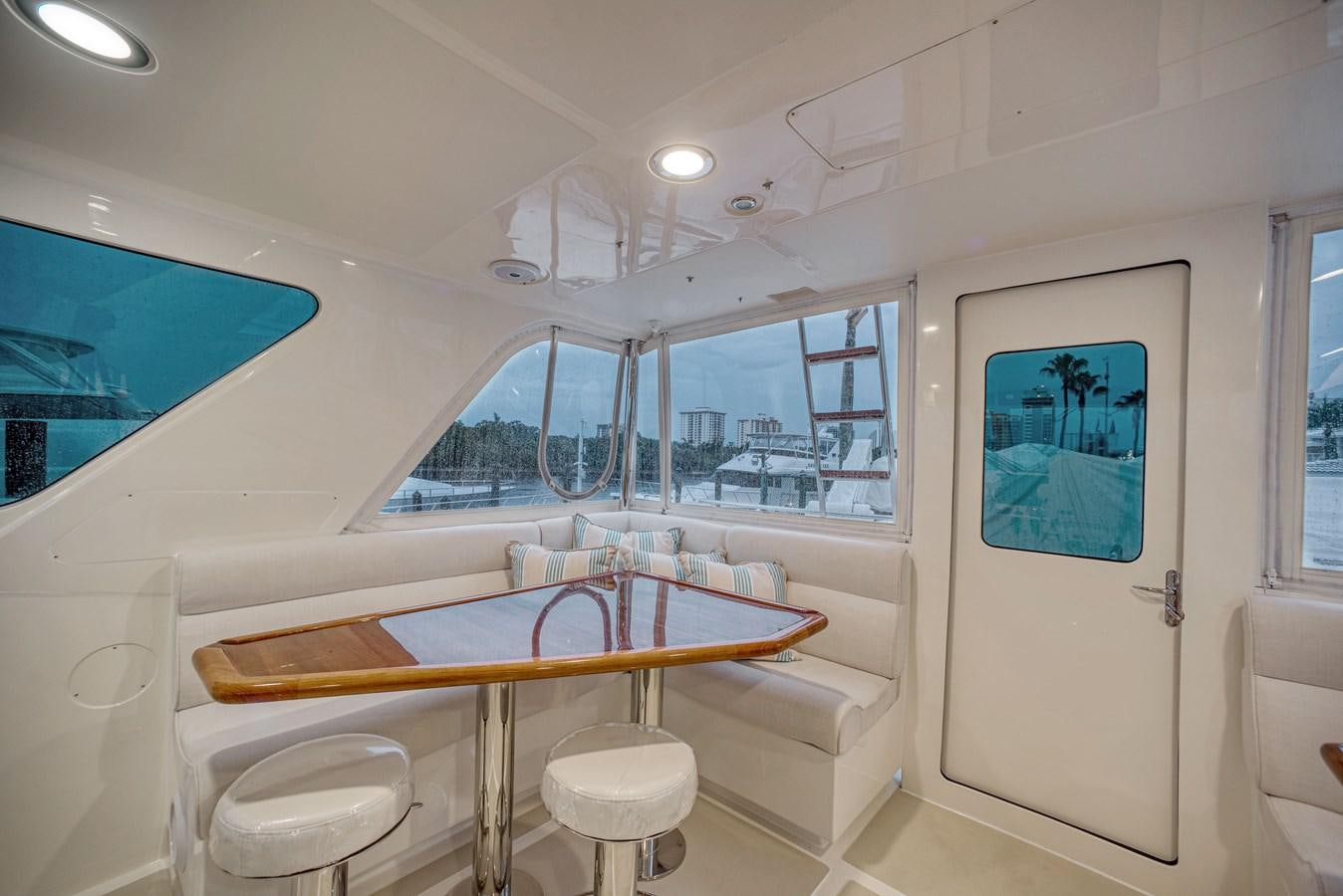 a room with a table and chairs aboard QUIXOTIC Yacht for Sale