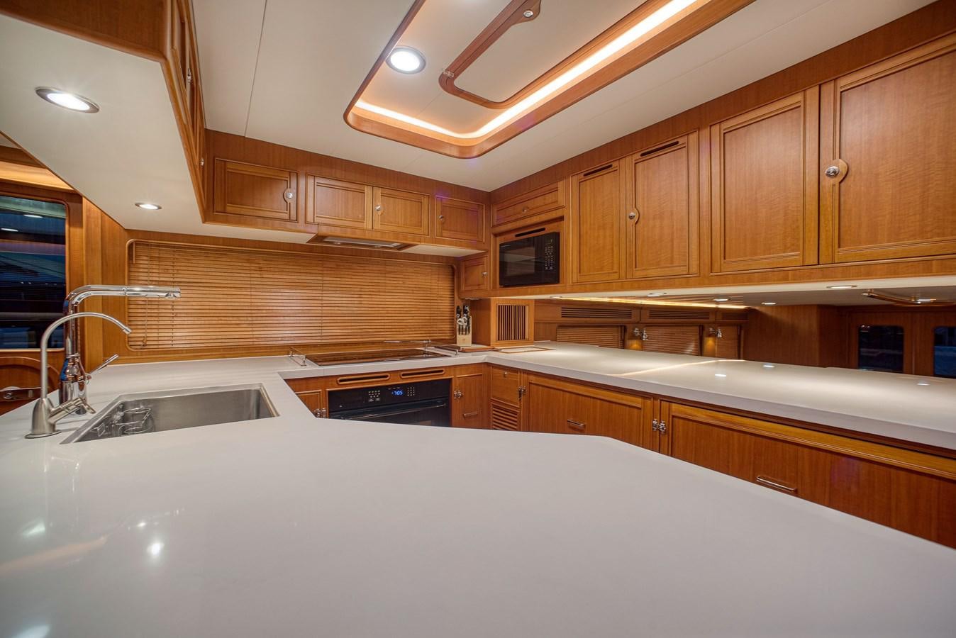 a kitchen with wooden cabinets aboard QUIXOTIC Yacht for Sale