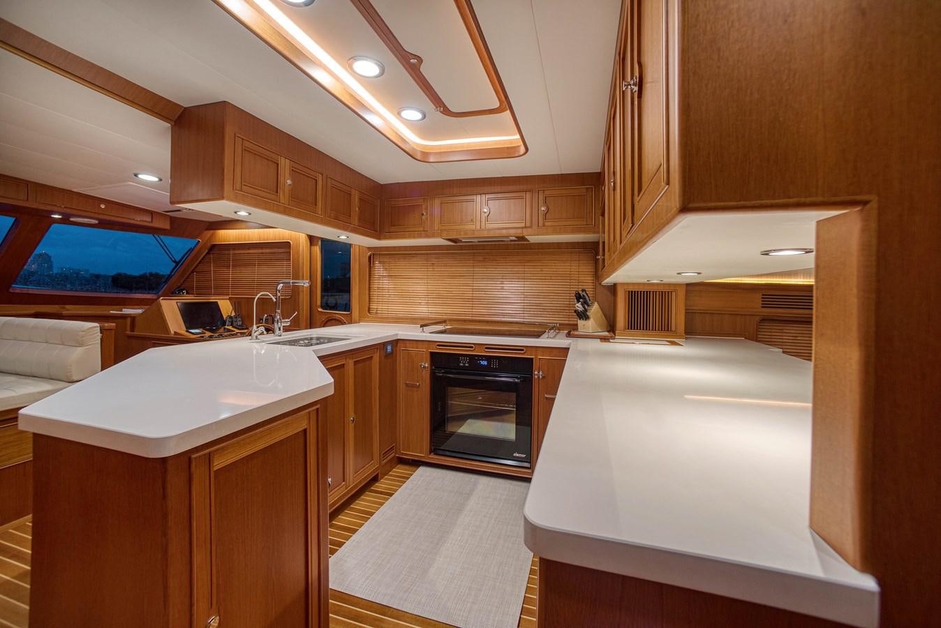 a kitchen with wooden cabinets aboard QUIXOTIC Yacht for Sale