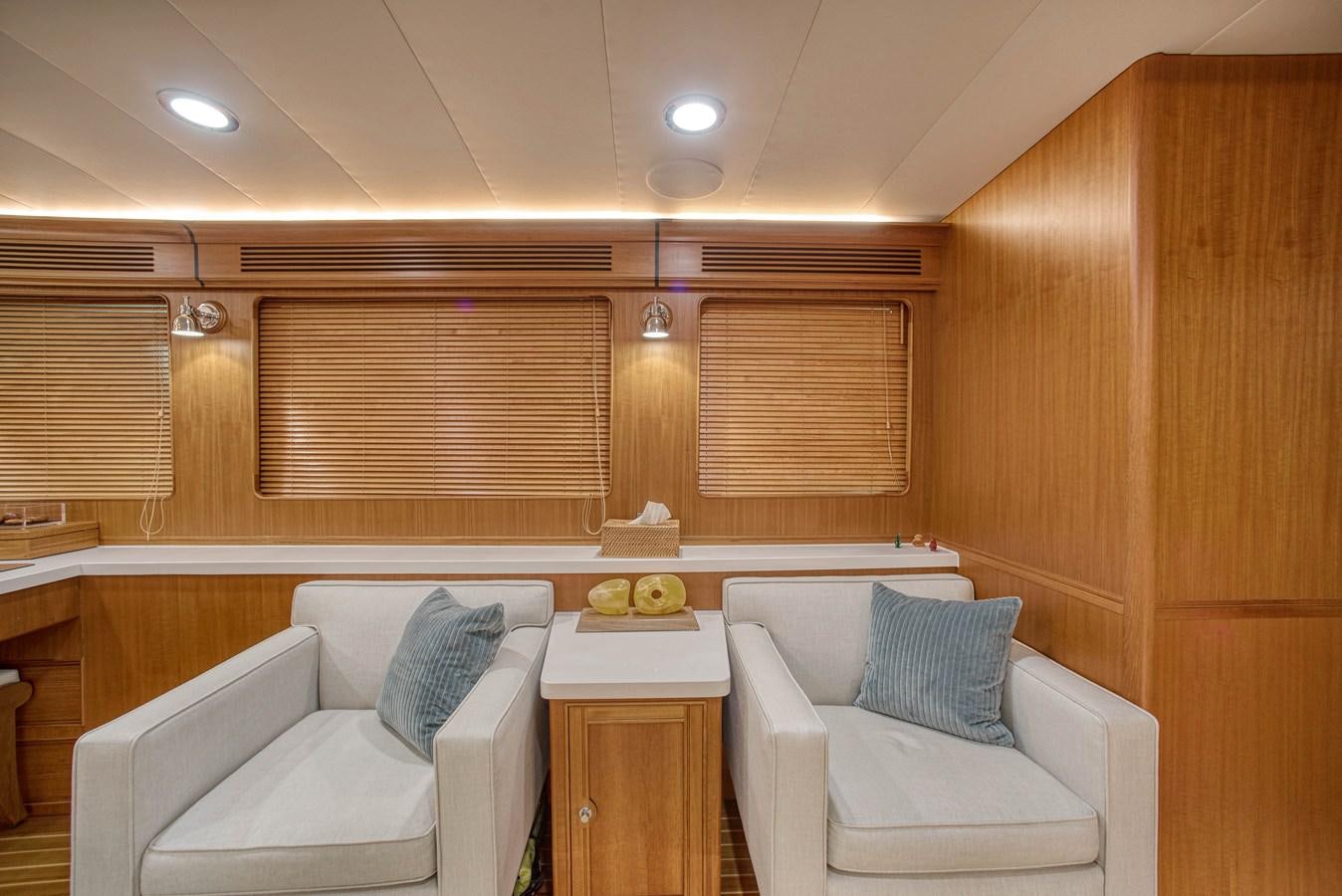 a room with a couch and a table and chairs aboard QUIXOTIC Yacht for Sale
