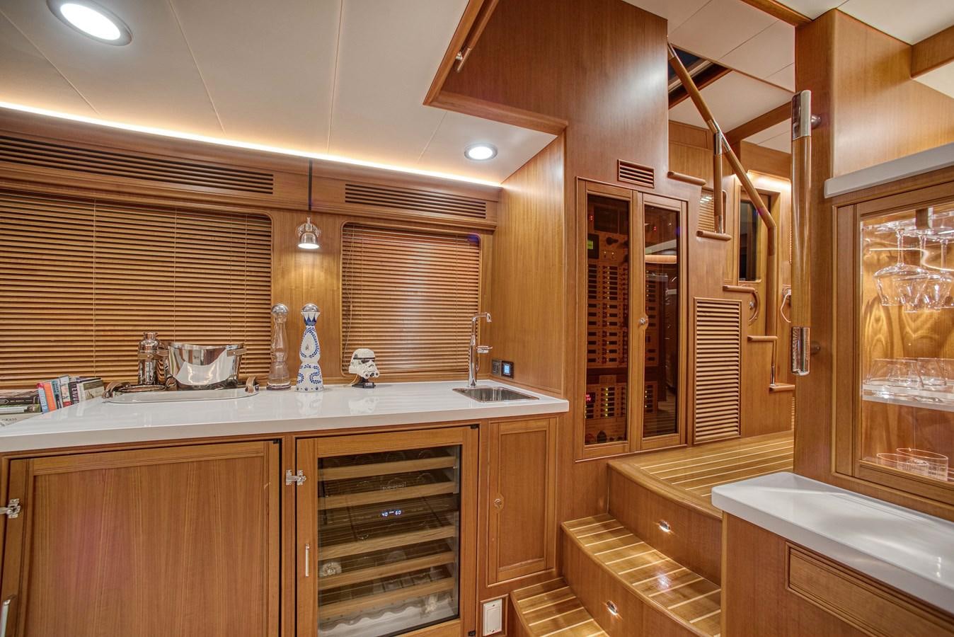 a kitchen with wooden cabinets aboard QUIXOTIC Yacht for Sale