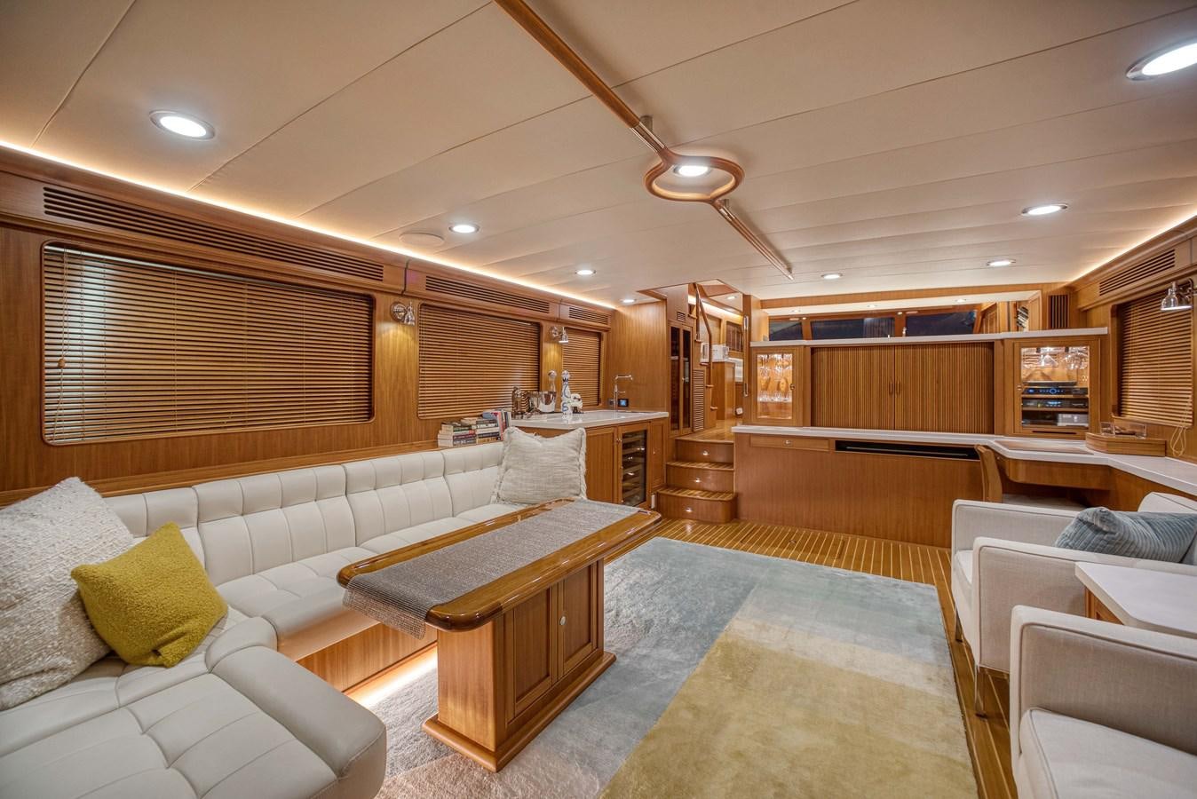 a room with a table and couches aboard QUIXOTIC Yacht for Sale