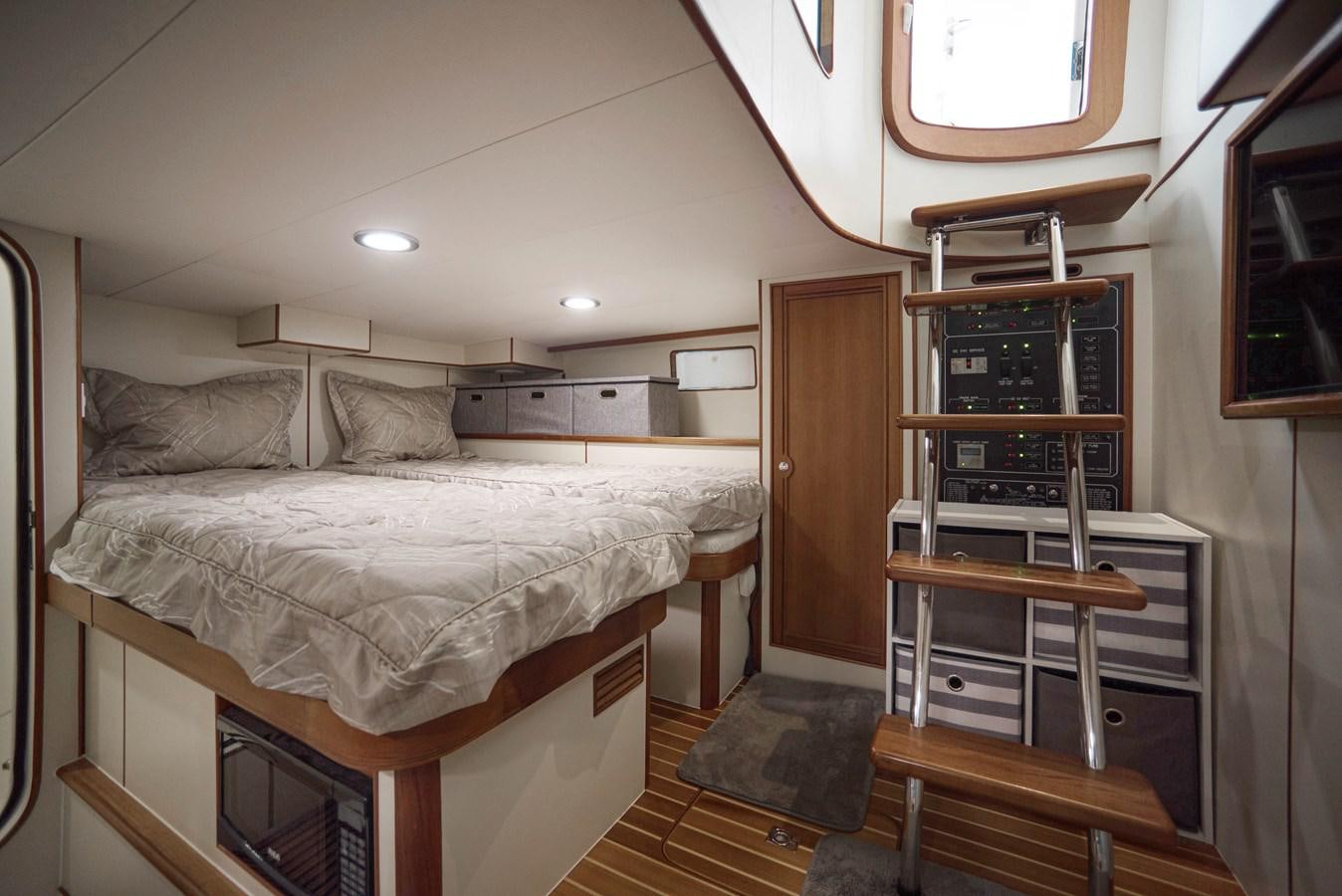 a bedroom with a bunk bed aboard QUIXOTIC Yacht for Sale
