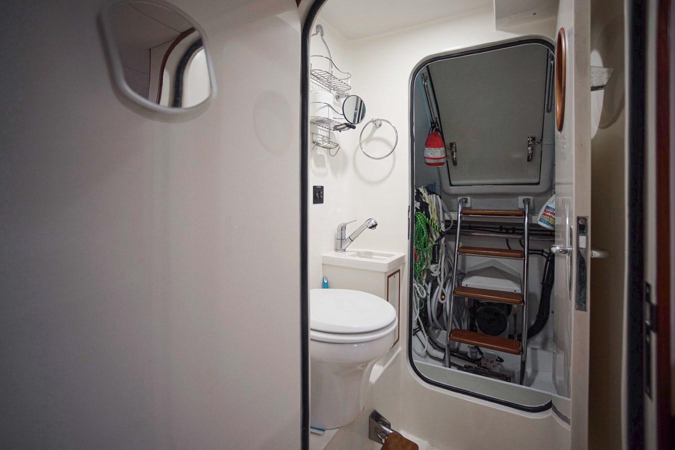 a toilet and sink in a bathroom aboard QUIXOTIC Yacht for Sale