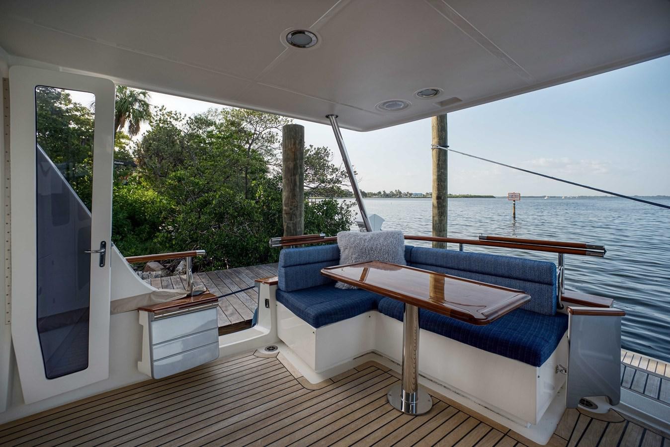 a deck with a pool and a deck with trees and a view of the water aboard MAGIC Yacht for Sale