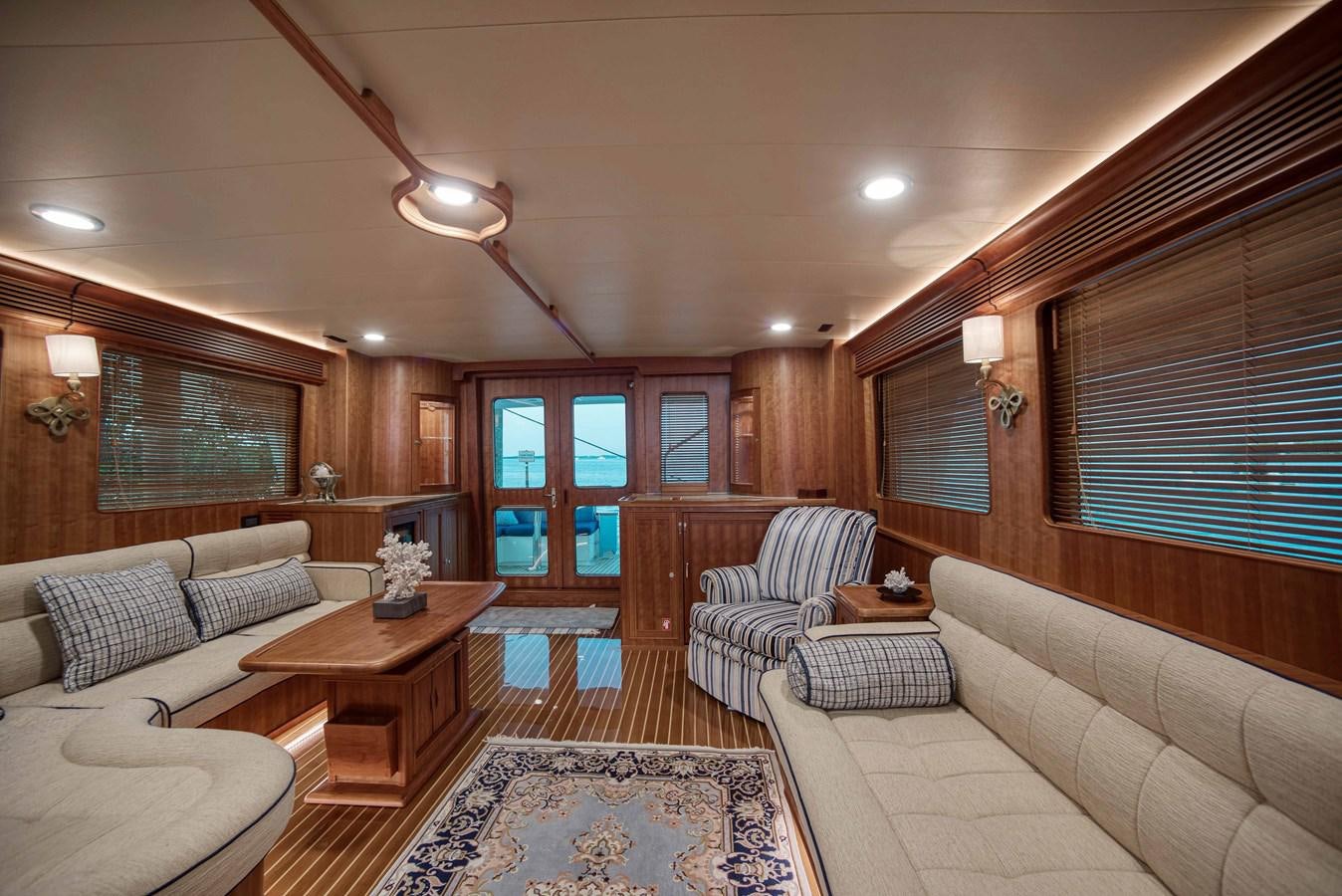 a living room with a couch and a table aboard MAGIC Yacht for Sale