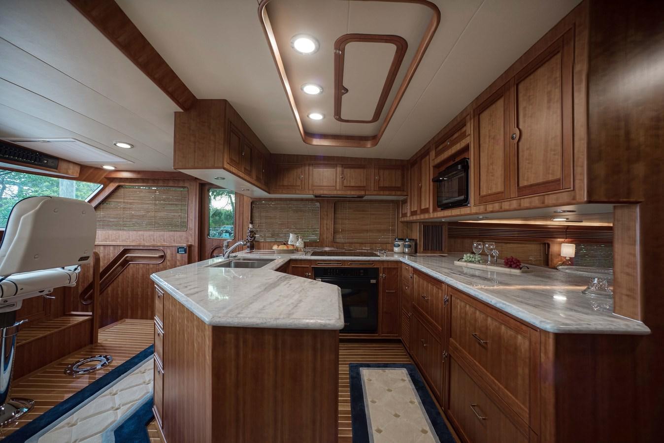 a kitchen with wooden cabinets aboard MAGIC Yacht for Sale