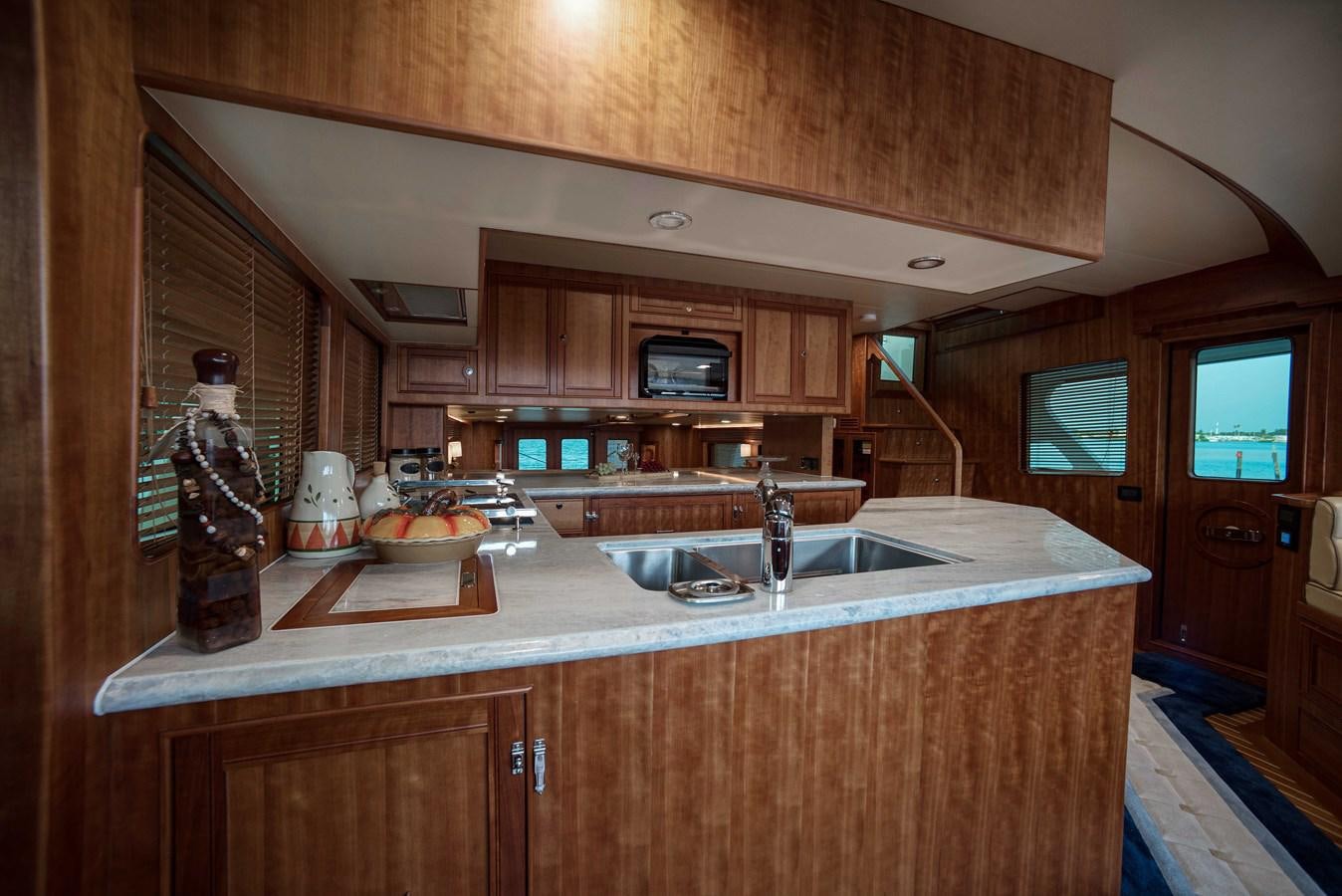 a kitchen with wooden cabinets aboard MAGIC Yacht for Sale