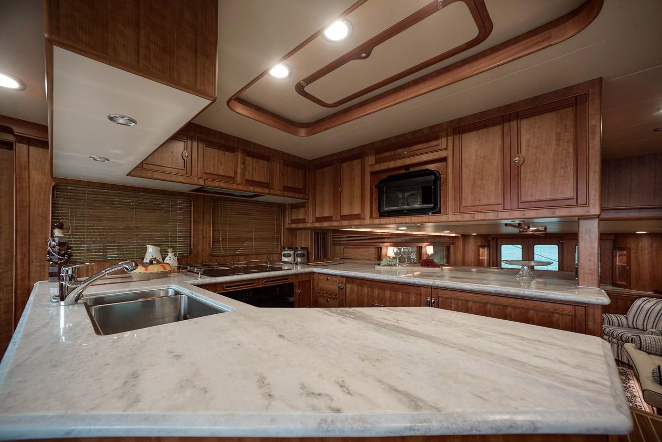 a kitchen with wooden cabinets aboard MAGIC Yacht for Sale