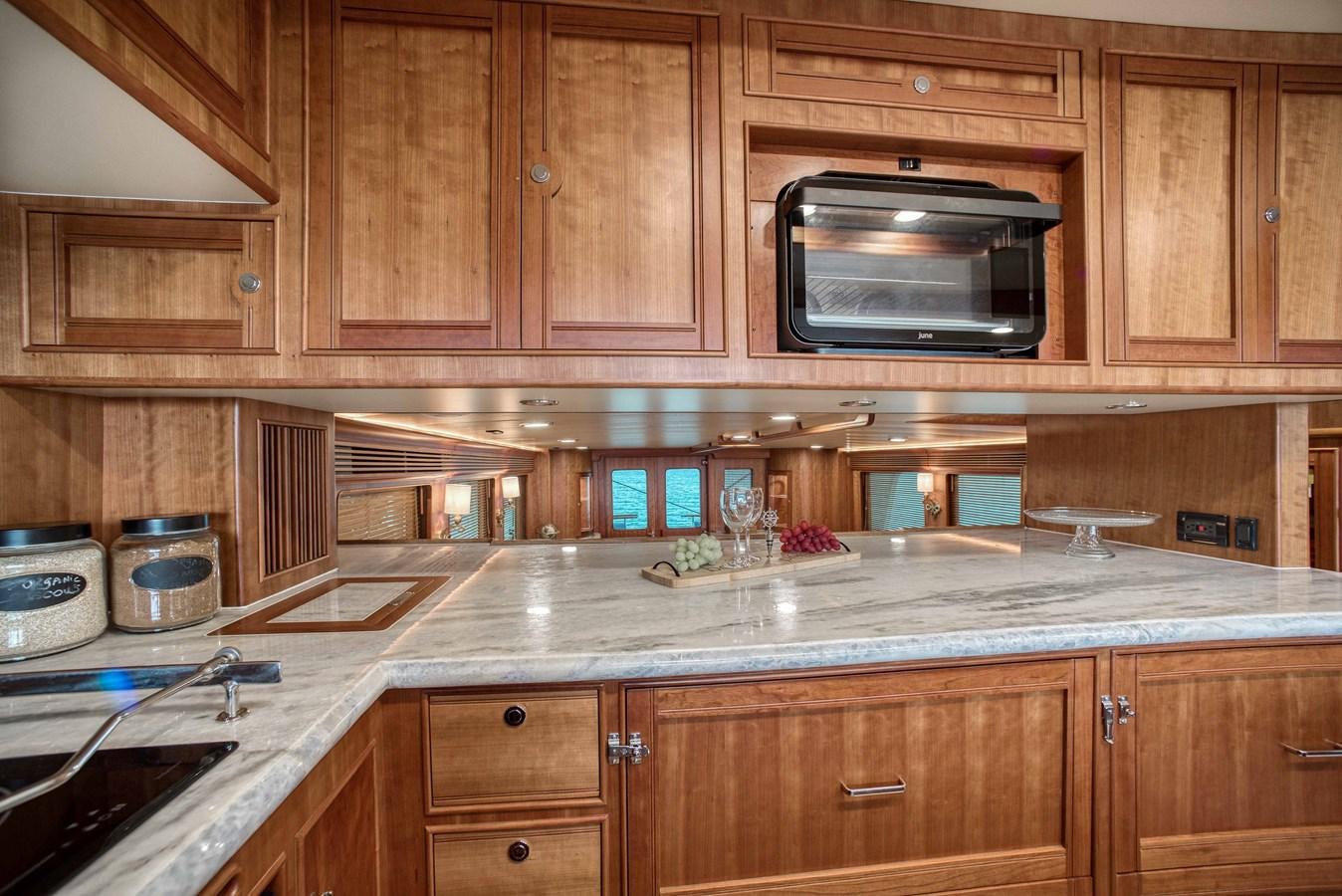 a kitchen with wooden cabinets aboard MAGIC Yacht for Sale