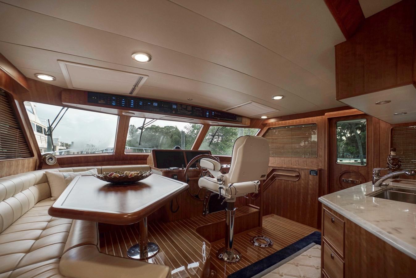 a living room with a table and chairs aboard MAGIC Yacht for Sale