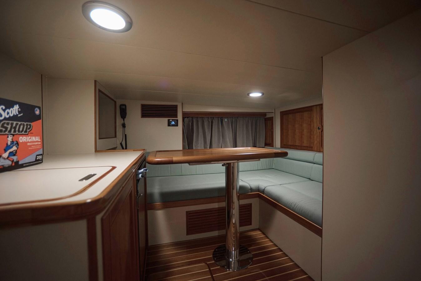 a room with a desk and a bed aboard MAGIC Yacht for Sale