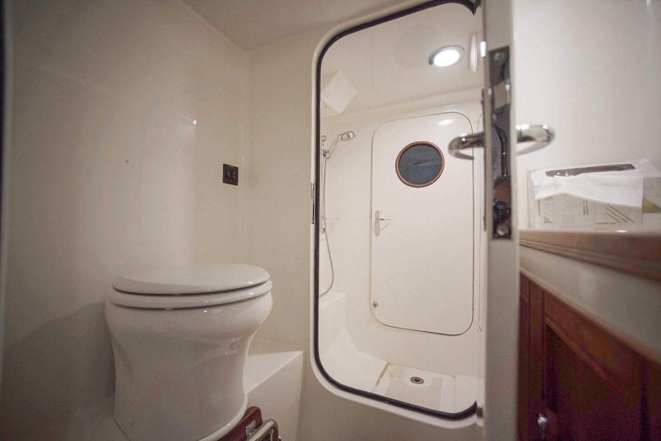 a toilet next to a washer aboard MAGIC Yacht for Sale