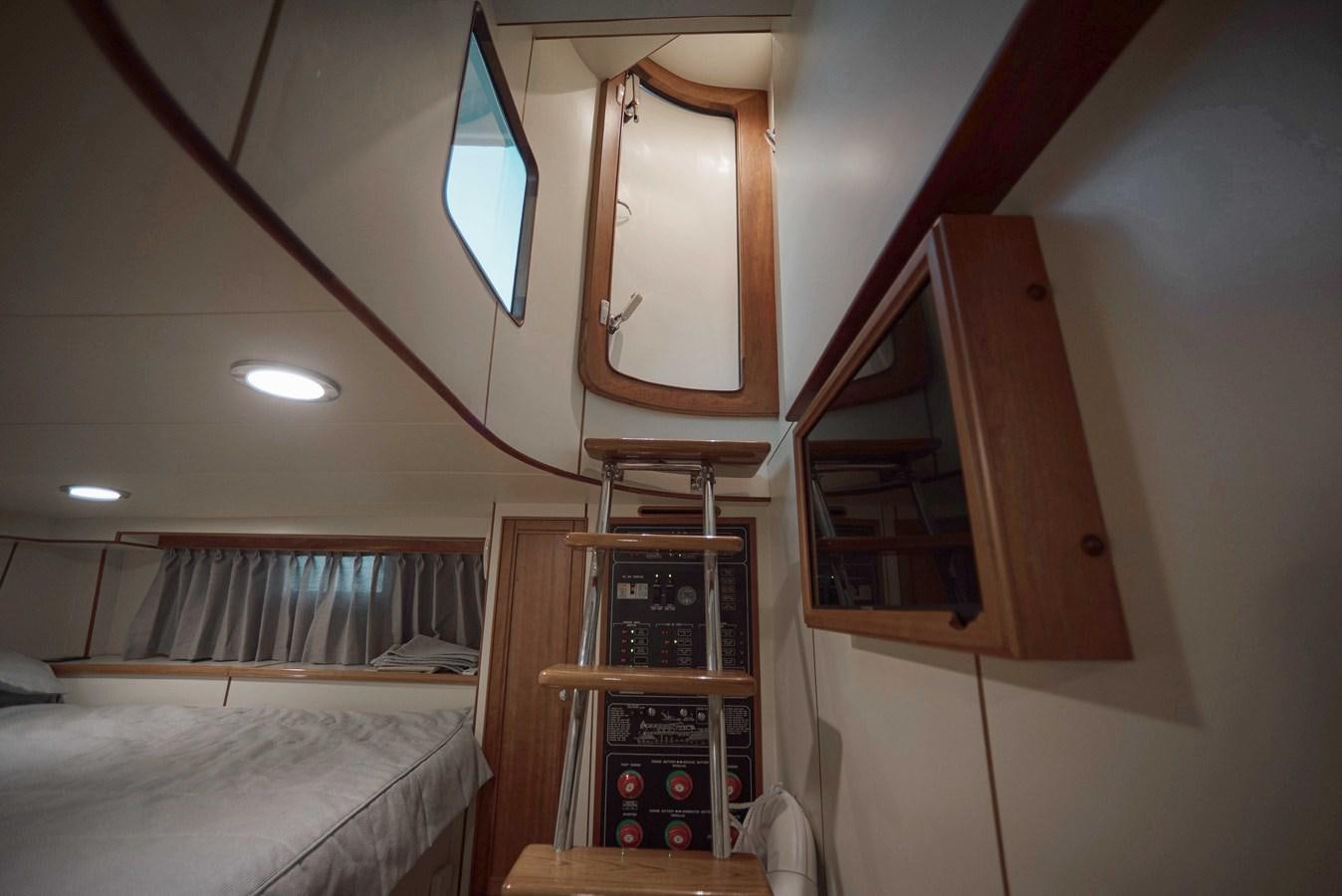 a small room with a bed and a shelf aboard MAGIC Yacht for Sale