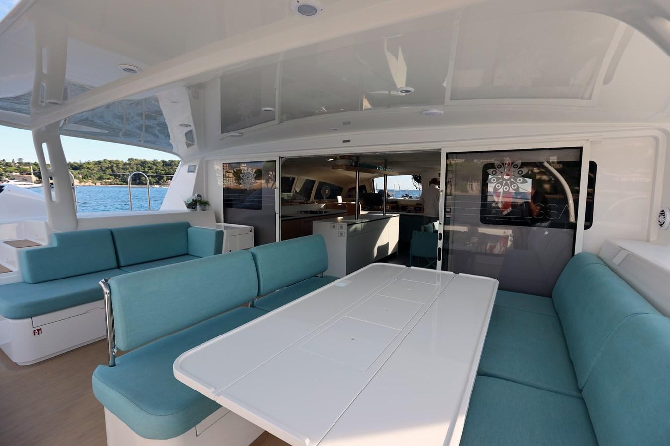 inside of a vehicle with a table and chairs and a white table aboard ELSSA Yacht for Sale
