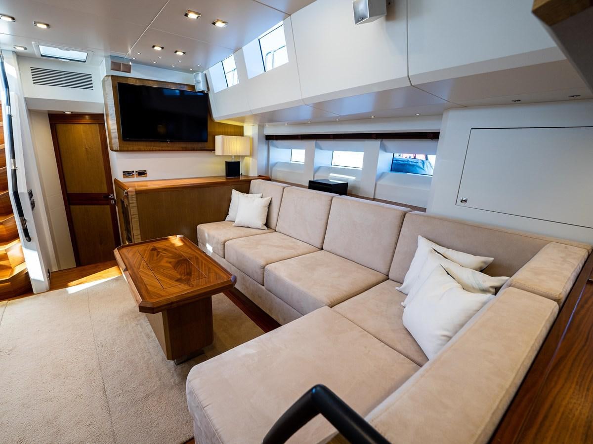 a living room with a couch and a television aboard BELKARA Yacht for Sale