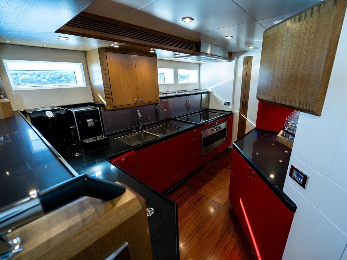 a kitchen with a stove and a sink aboard BELKARA Yacht for Sale