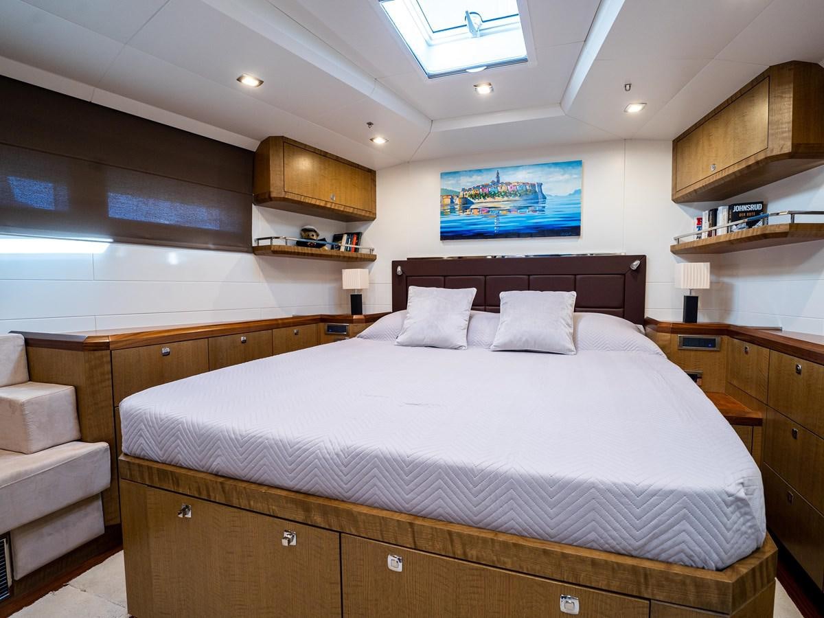 a bed with a white bed spread aboard BELKARA Yacht for Sale