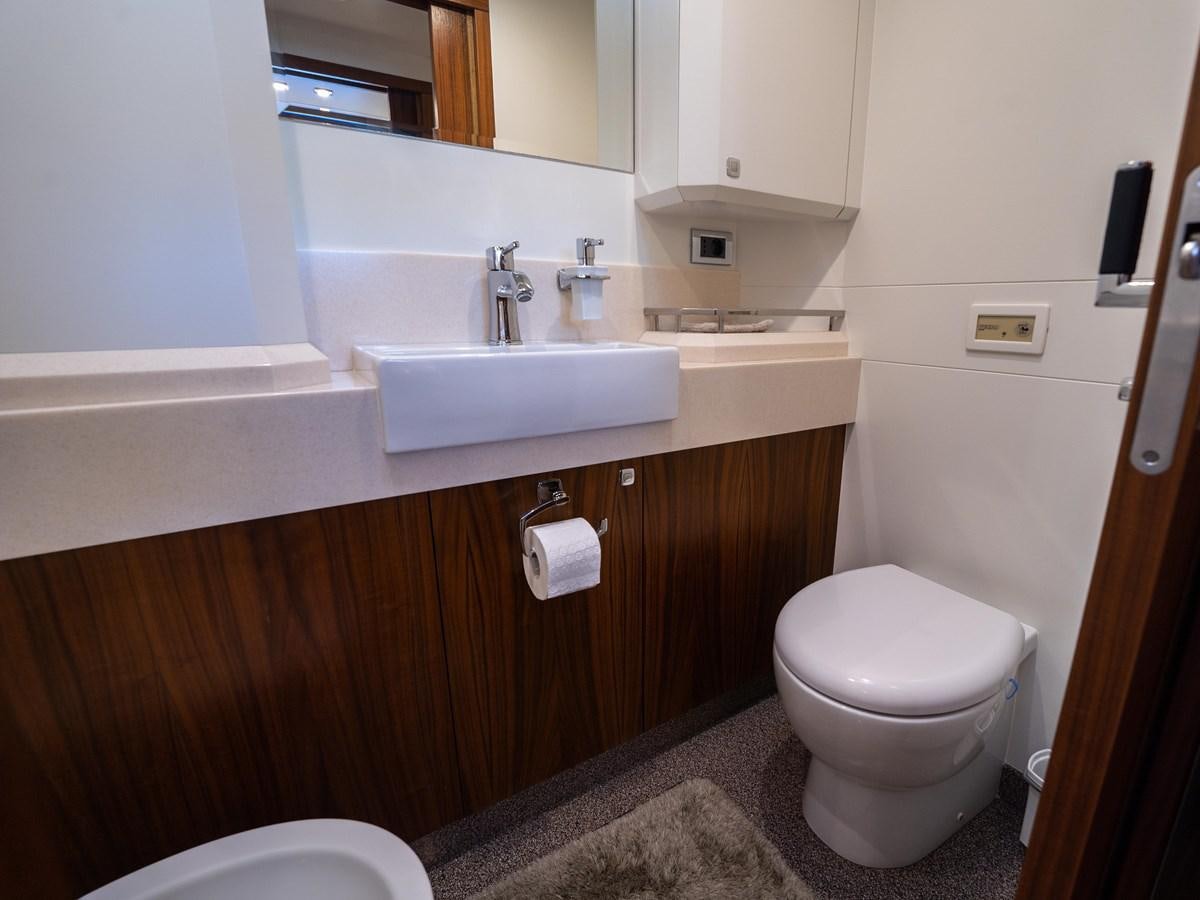 a bathroom with a sink toilet and a mirror aboard BELKARA Yacht for Sale