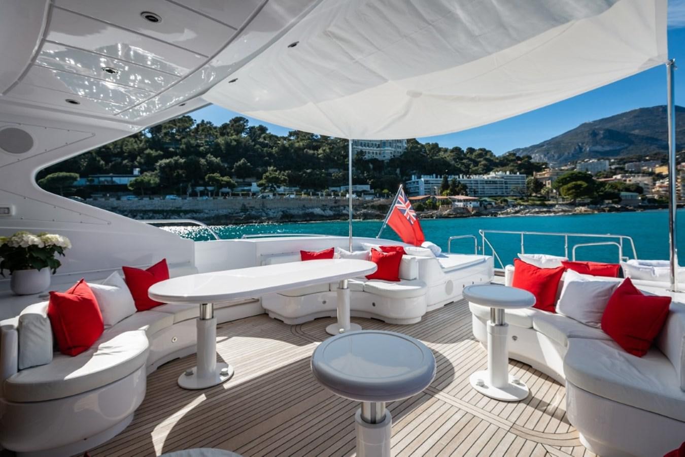 a lounge area with a large white tent and a view of a city aboard BELISA Yacht for Sale
